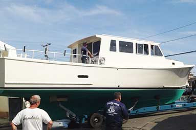 View from ground level looking slightly up at the side of the boat out in the open and almost done