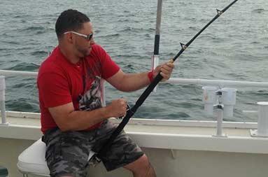 One of the guys sitting down reeling in a 35lb fish