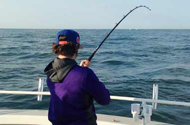 One of the guys, AJ, hooks into a 30+ pound bass.
