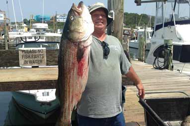 One of the guys back at the marina holding up the large bass he caught