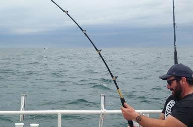 One of the guys with a grip on his reel as the line is in the water