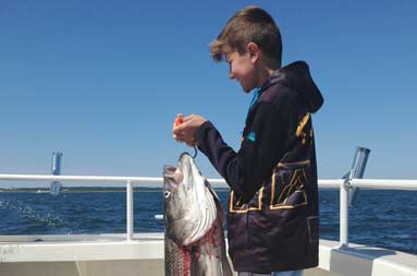 One of the young boys with the bass he caught
