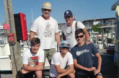 All of the guys back at the dock at the marina posing with their fish laid out in front of them