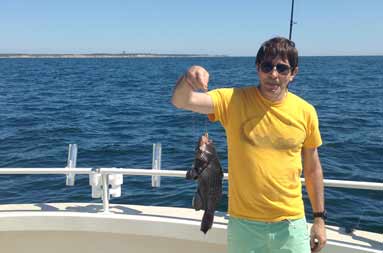 Another shot of one of kids looking at a porgy that he caught hanging on the line