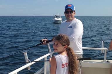 One of the daughters fishing with the dad
