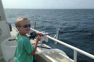 One of the kids fishing with sunglasses on
