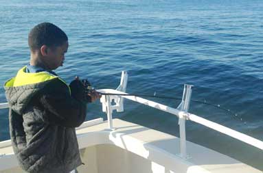One of the younger kids with his line in the water