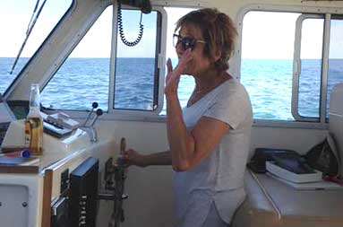 Capt. Jill's mom, Phyllis, at the captain's wheel!
