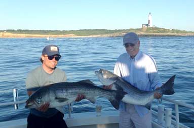 Father and son, Jim & Jim both holding up the striped bass they caught