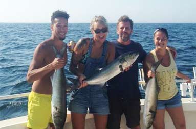 Group photo of the guests and their catch.
