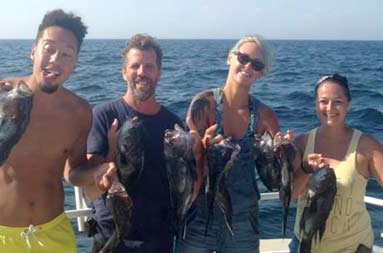 Group photo of the guests and their catch.