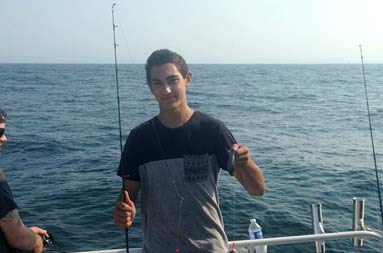 One of the guys holding up his catch, still on the line