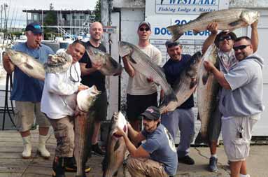 The group poses with their catch of slob bass today back at the marina.