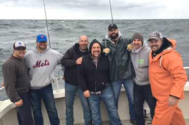 Group shot of the guys in their fall/winter clothing on an overcast day smiling into the camera