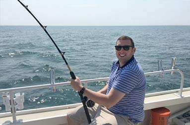 A second guy with reel in water waiting for a bite.