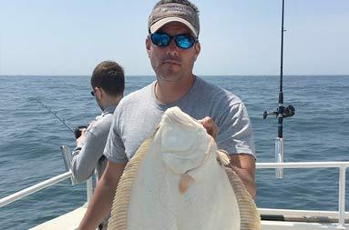 Capt. Steve holding up a fluke