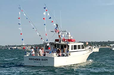 The NRC at sea decorated with the American flag and red, white and blue banners.